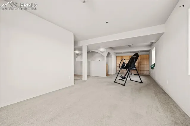 a view of a room with chairs and a table