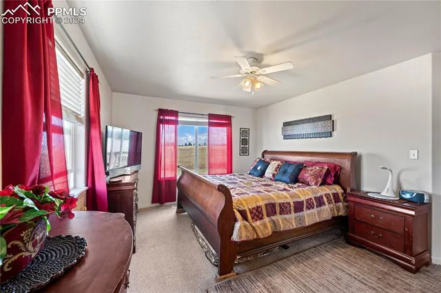 a bedroom with a bed couch and a window