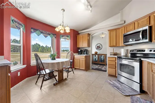 a view of a dining room with furniture window and outside view