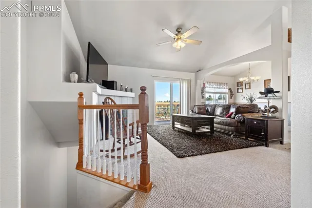 a living room with furniture and kitchen view