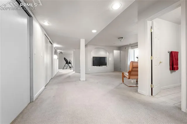 a view of a hallway with wooden floor and furniture