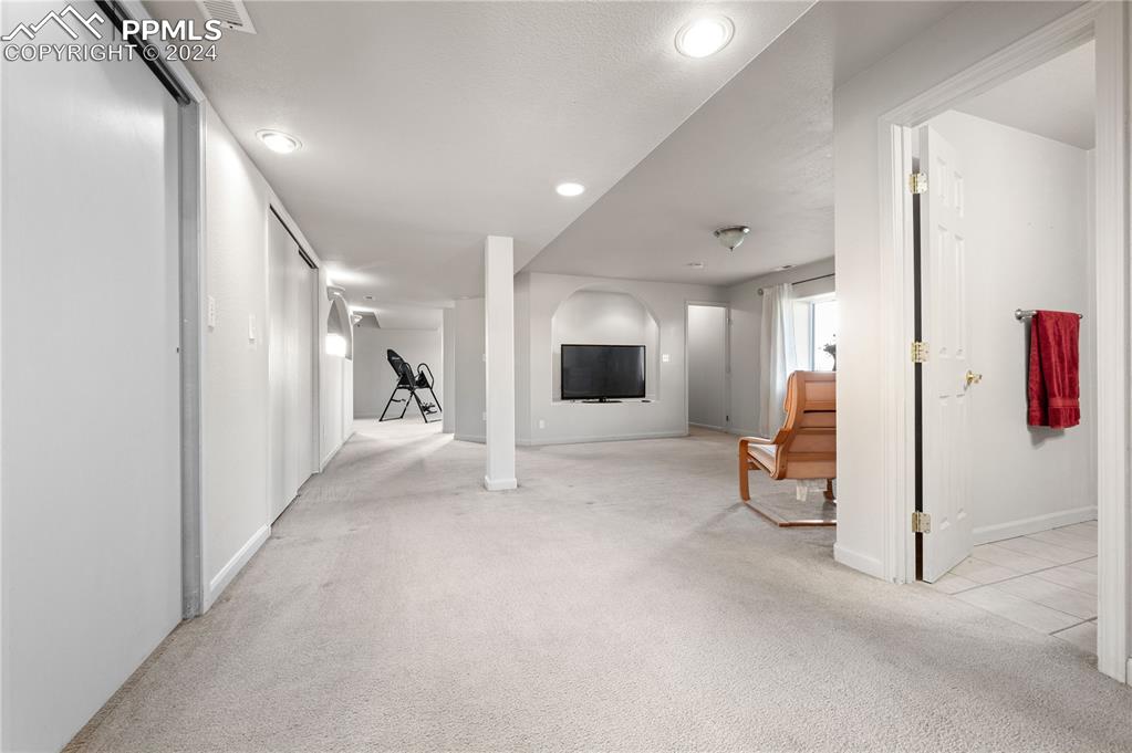 17950 Cumbres Road Peyton, CO 80831 - Photo 6 of 21 a view of a hallway with wooden floor and furniture