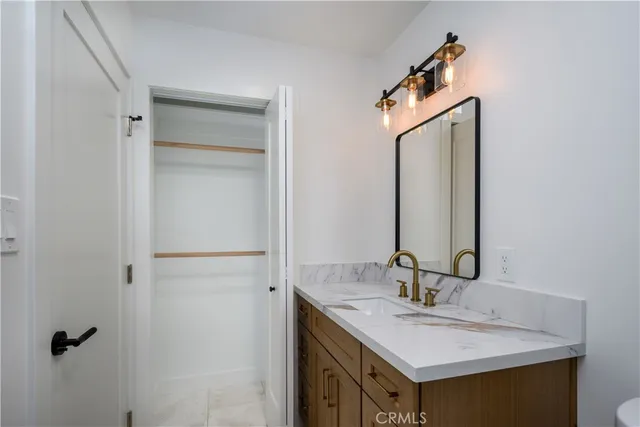 a bathroom with a sink vanity and a mirror