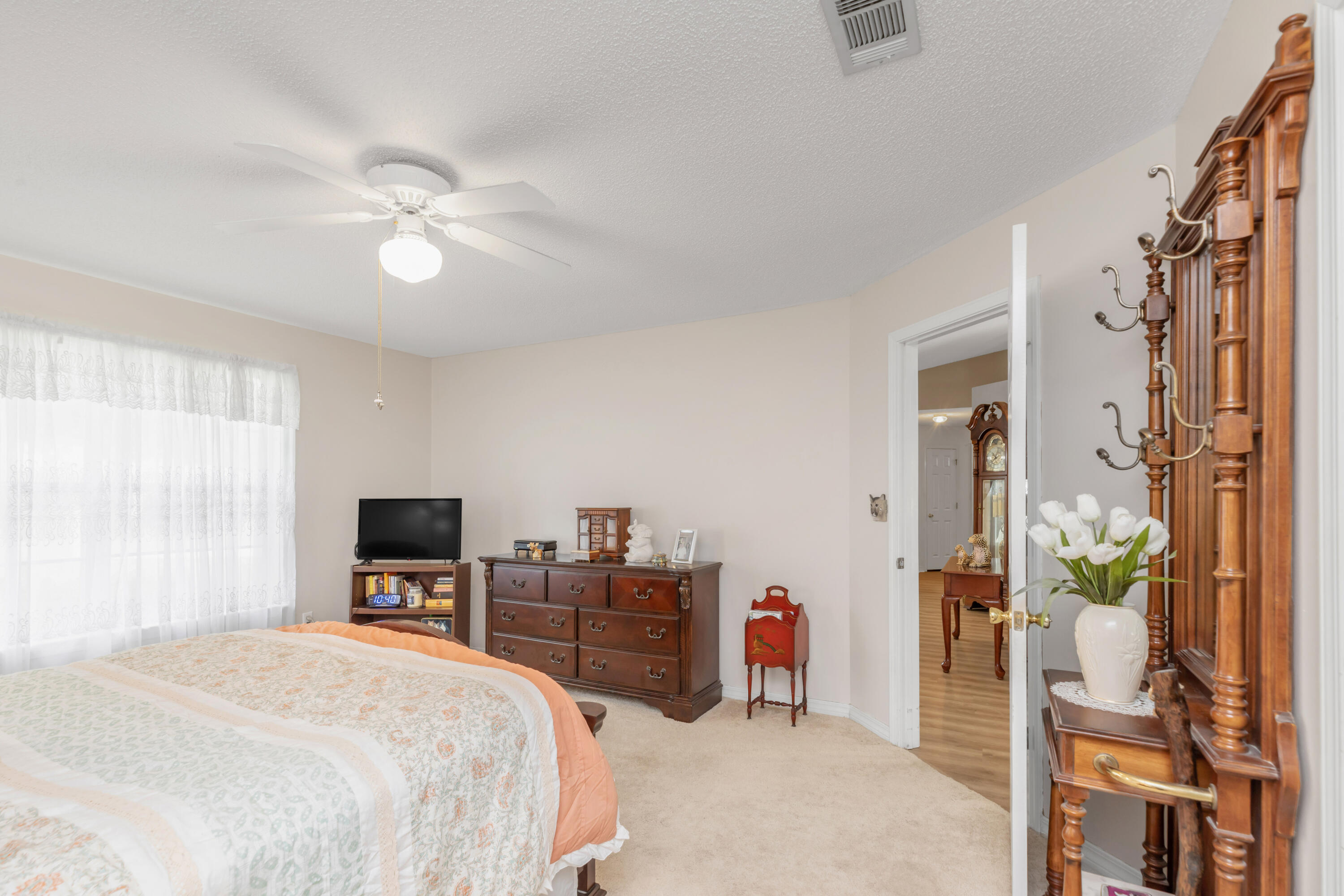 1244 Jefferyscot Drive Crestview, FL 32536 - Photo 26 of 40 a bedroom with a bed dresser and a flat tv screen