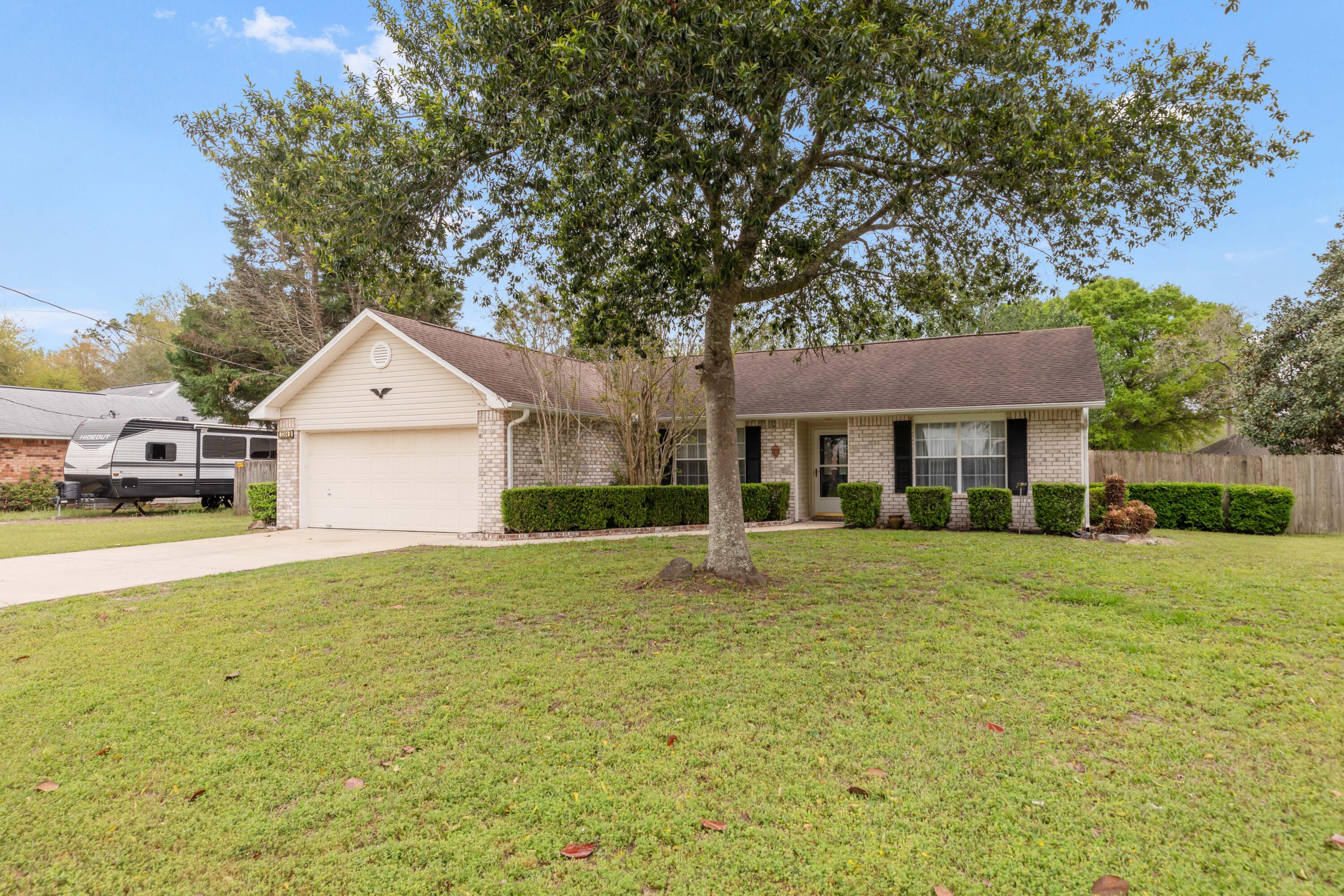 1244 Jefferyscot Drive Crestview, FL 32536 - Photo 5 of 40 a front view of a house with a yard and garage