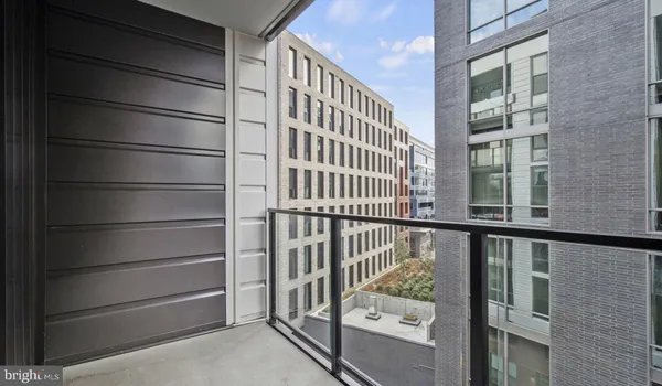 a bedroom with a bed and glass walk in closet