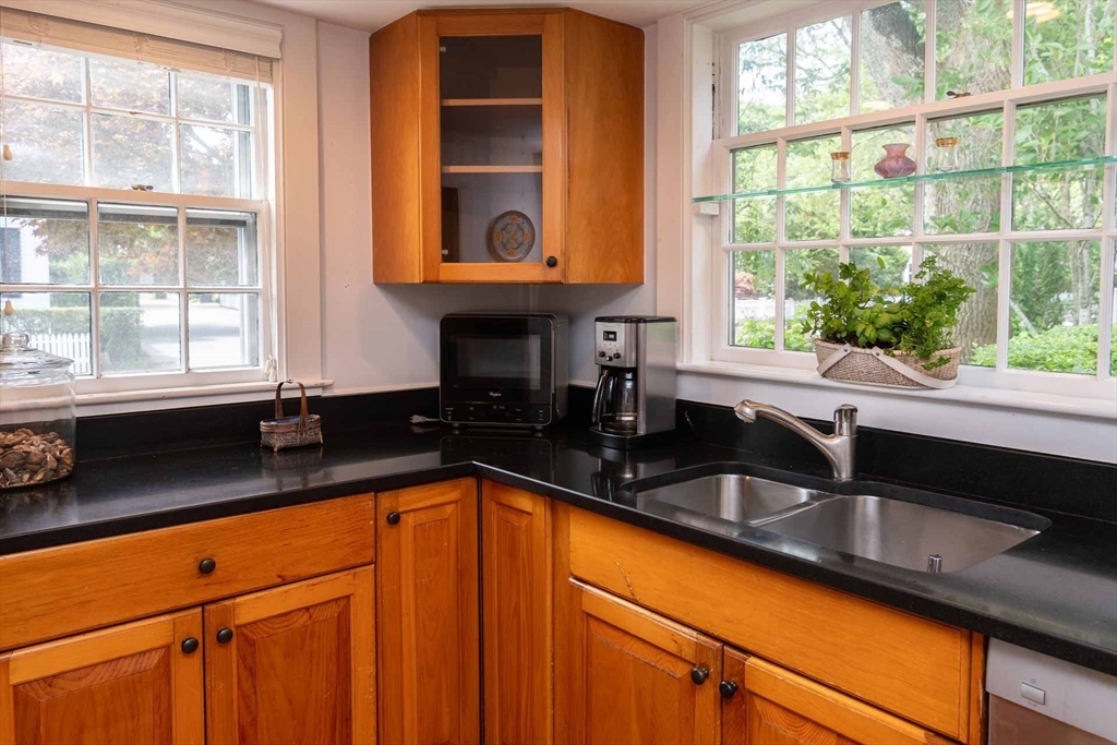 2 Green Avenue Edgartown, MA 02539 - Photo 16 of 42 a kitchen with granite countertop a sink and a window