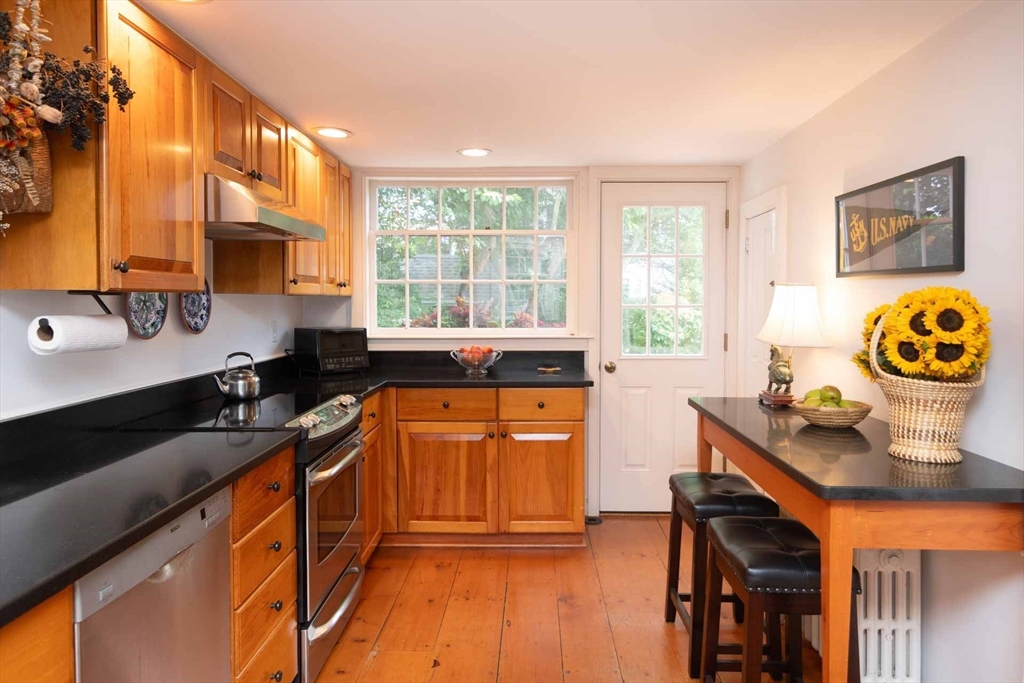 2 Green Avenue Edgartown, MA 02539 - Photo 17 of 42 a kitchen with stainless steel appliances granite countertop a stove a sink and a microwave
