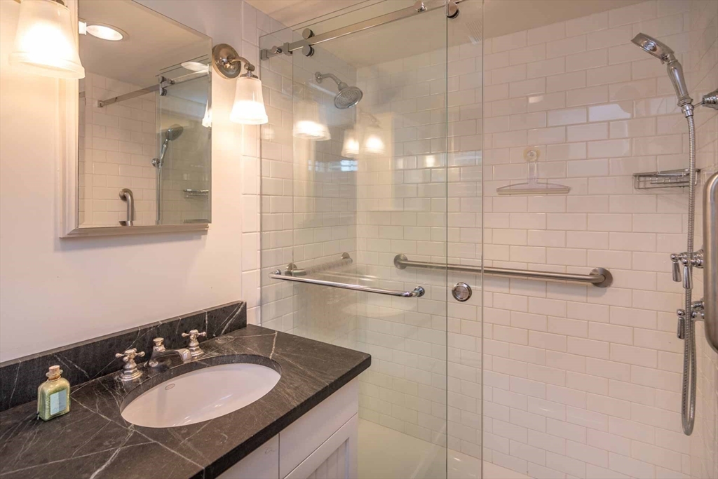 2 Green Avenue Edgartown, MA 02539 - Photo 25 of 42 a bathroom with a sink mirror and shower