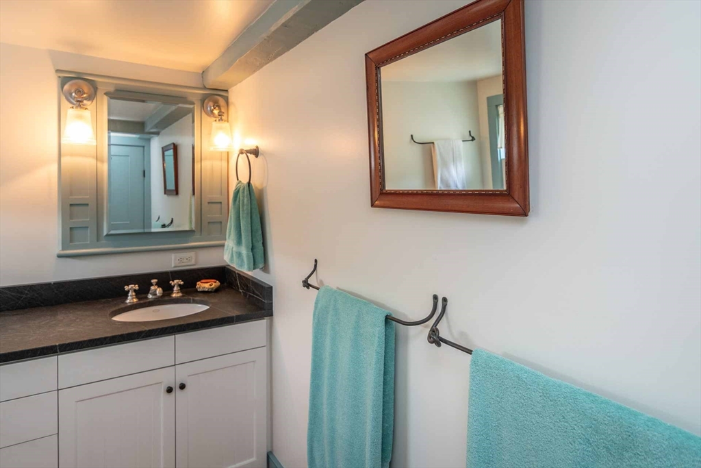 2 Green Avenue Edgartown, MA 02539 - Photo 28 of 42 a bathroom with a granite countertop sink and mirror