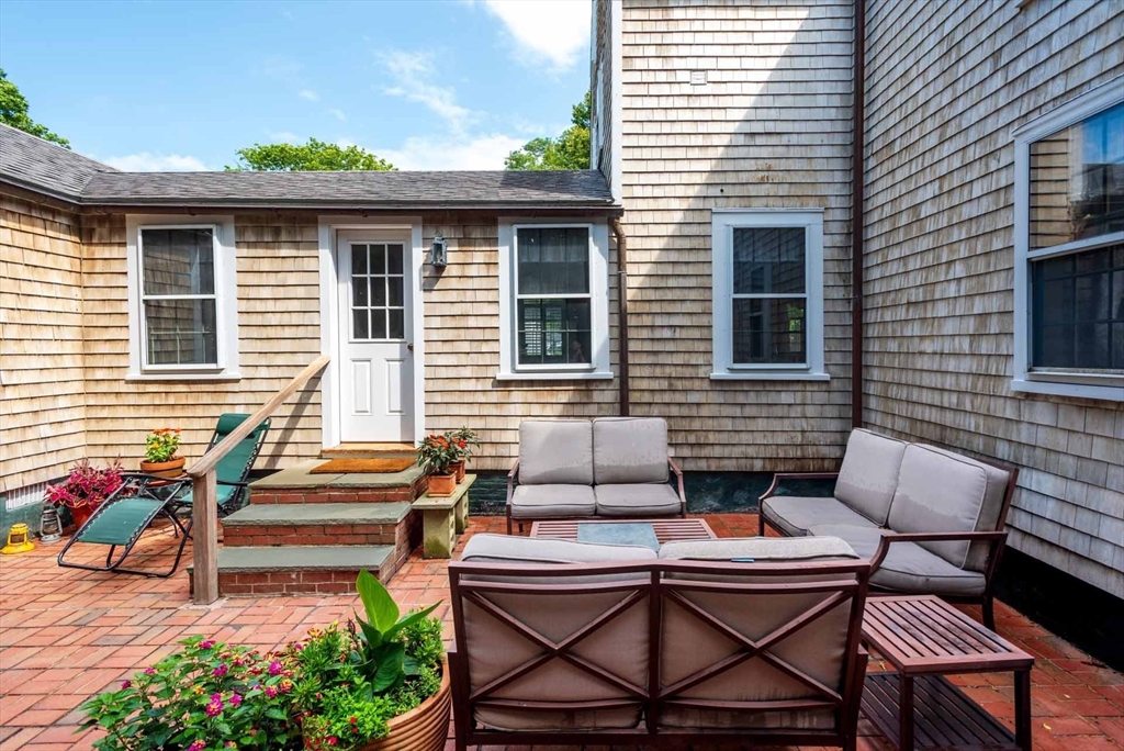 2 Green Avenue Edgartown, MA 02539 - Photo 38 of 42 a backyard of a house with outdoor seating