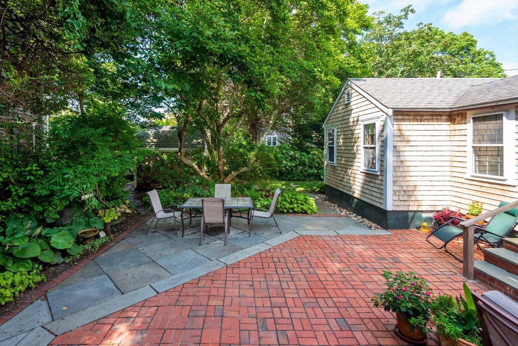 2 Green Avenue Edgartown, MA 02539 - Photo 40 of 42 a backyard of a house with table and chairs