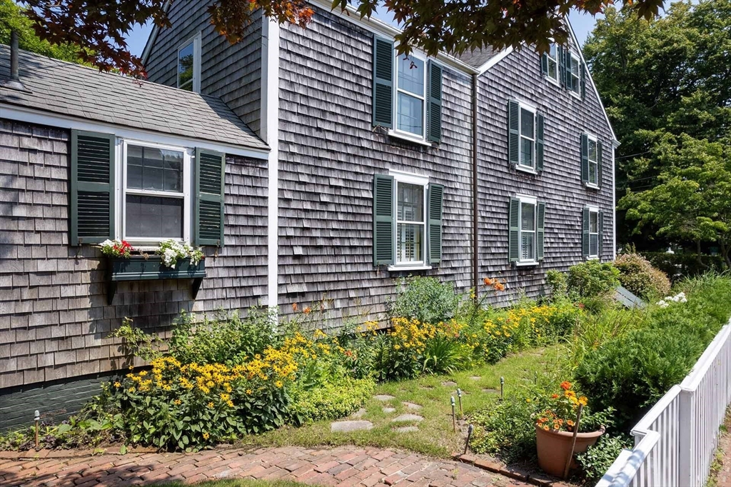 2 Green Avenue Edgartown, MA 02539 - Photo 4 of 42 a view of a house with chairs and potted plants