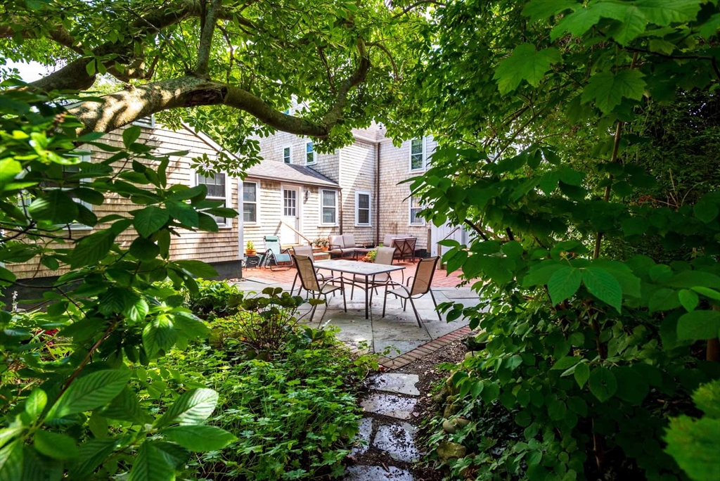 2 Green Avenue Edgartown, MA 02539 - Photo 41 of 42 a view of a patio with table and chairs and potted plants