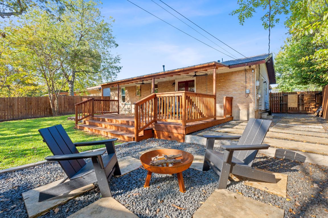 a backyard of a house with barbeque oven table and chairs