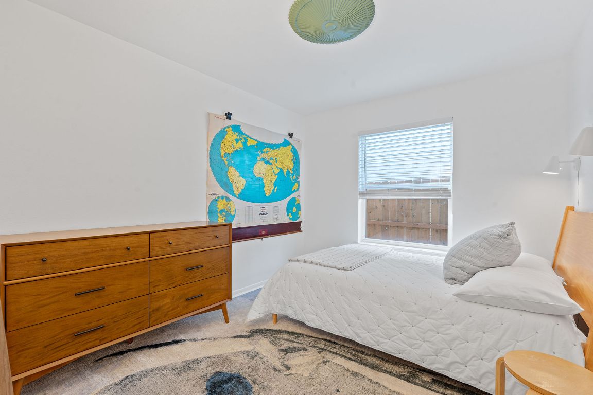 8801 Redfield Lane Austin, TX 78758 - Photo 20 of 31 a bedroom with a bed and window