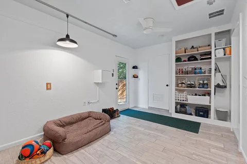 a living room with furniture cabinets and a rug