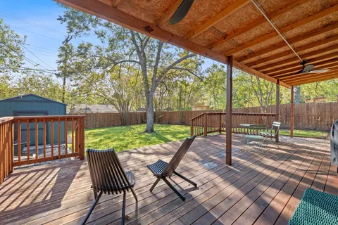 a view of backyard with wooden floor and outdoor seating