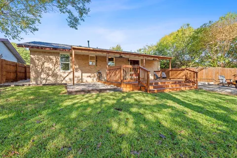 a view of a backyard with table and chairs and wooden fence