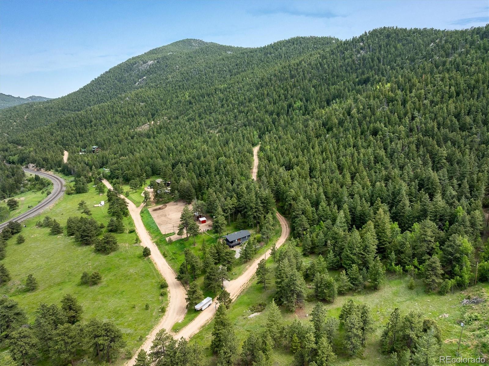 1546 Chute Road Golden, CO 80403 - Photo 11 of 36 a view of a lush green forest with trees in the background