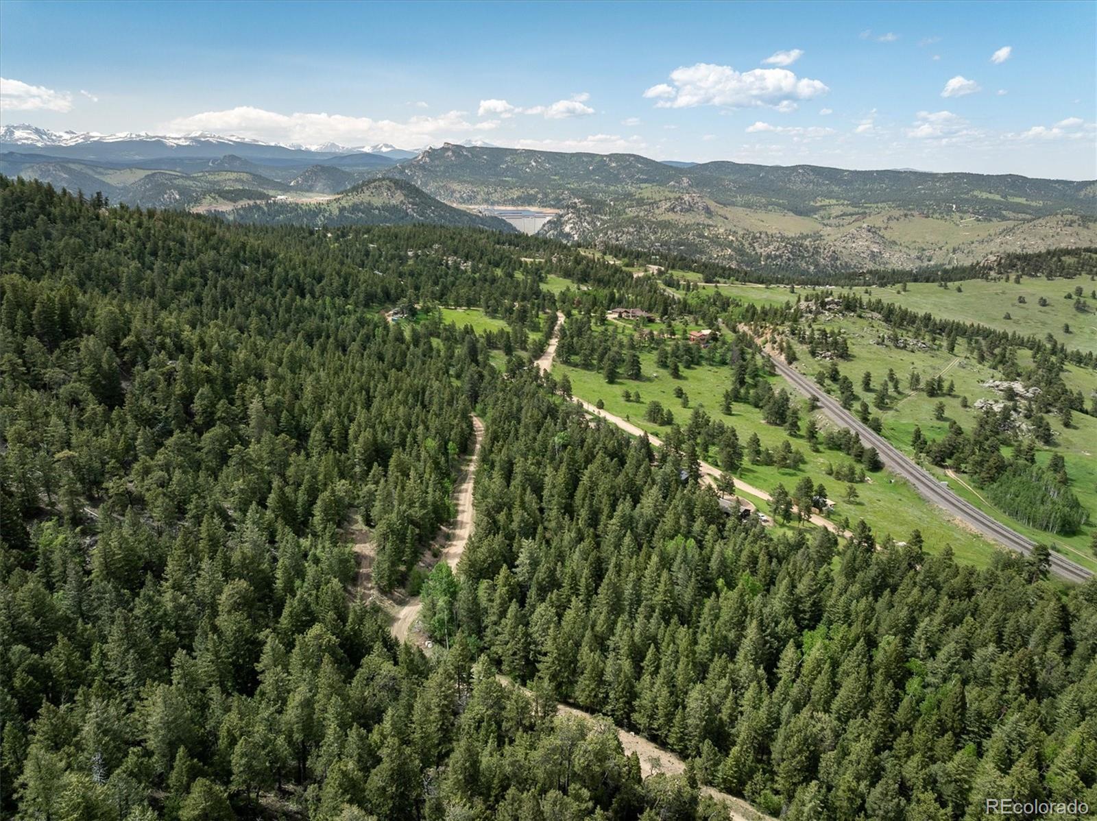 1546 Chute Road Golden, CO 80403 - Photo 18 of 36 a view of a mountain with a lush green hillside