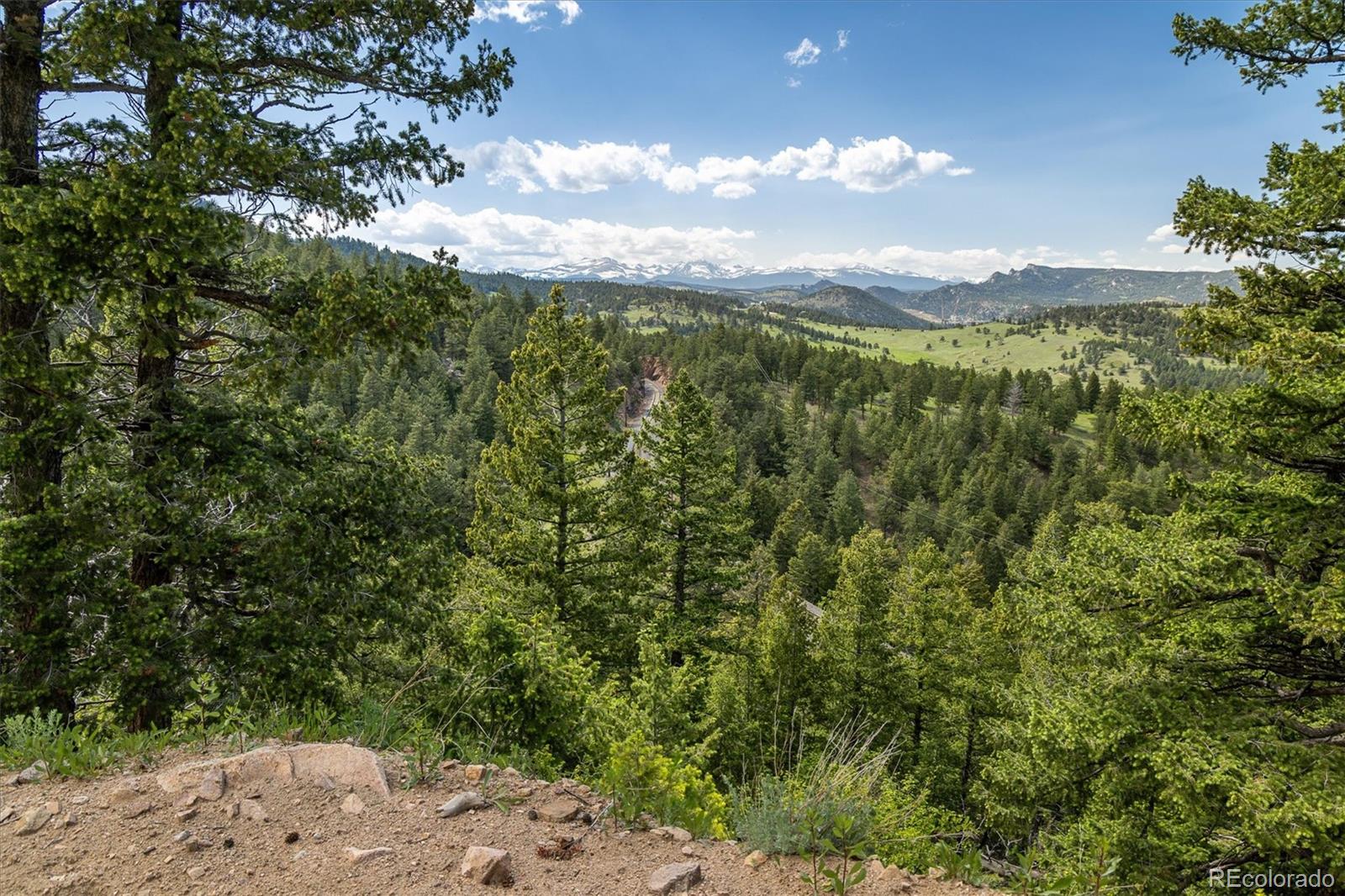 1546 Chute Road Golden, CO 80403 - Photo 2 of 36 a view of a city with lush green forest