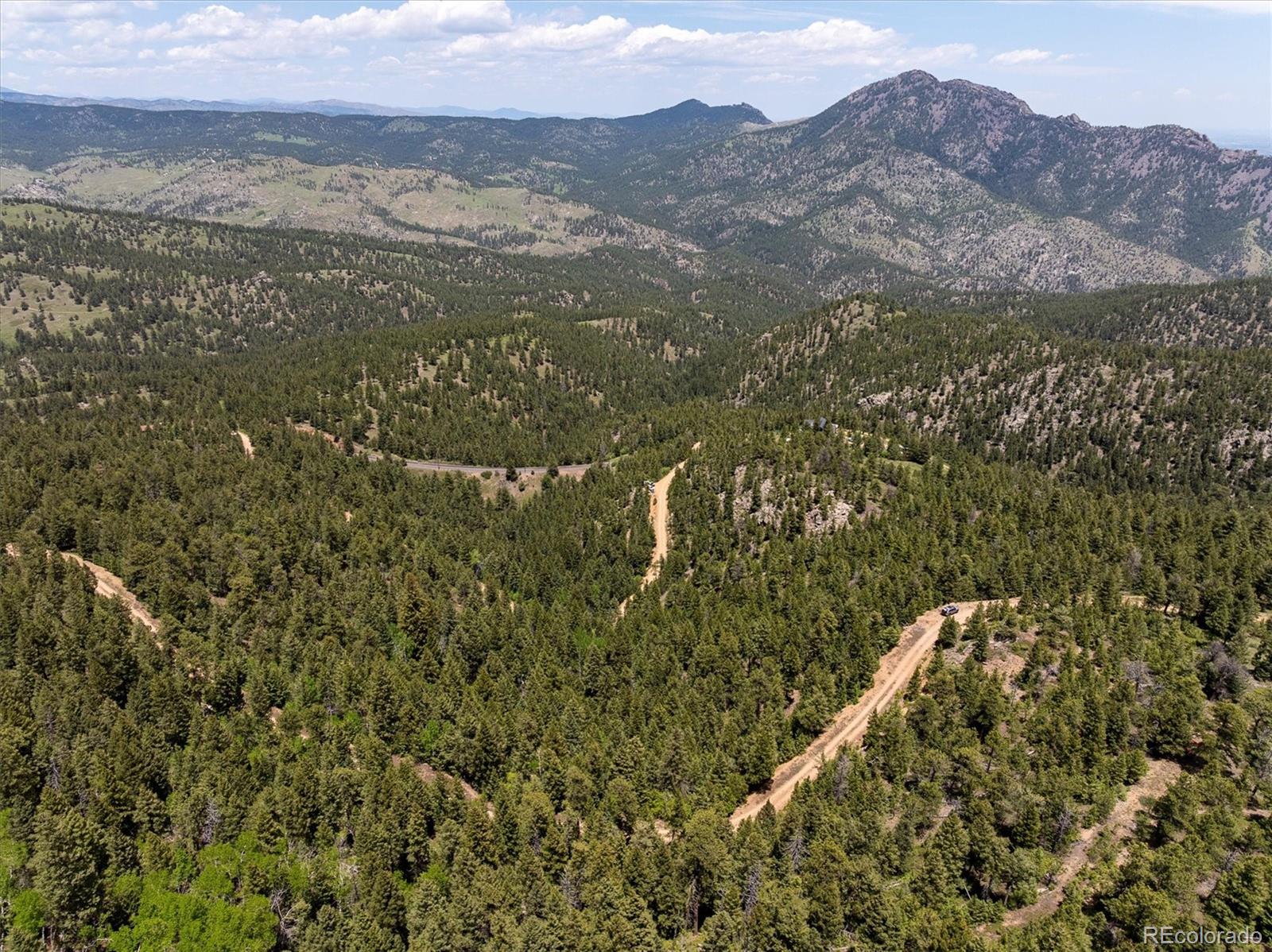 1546 Chute Road Golden, CO 80403 - Photo 28 of 36 a view of a mountain in the distance in a field