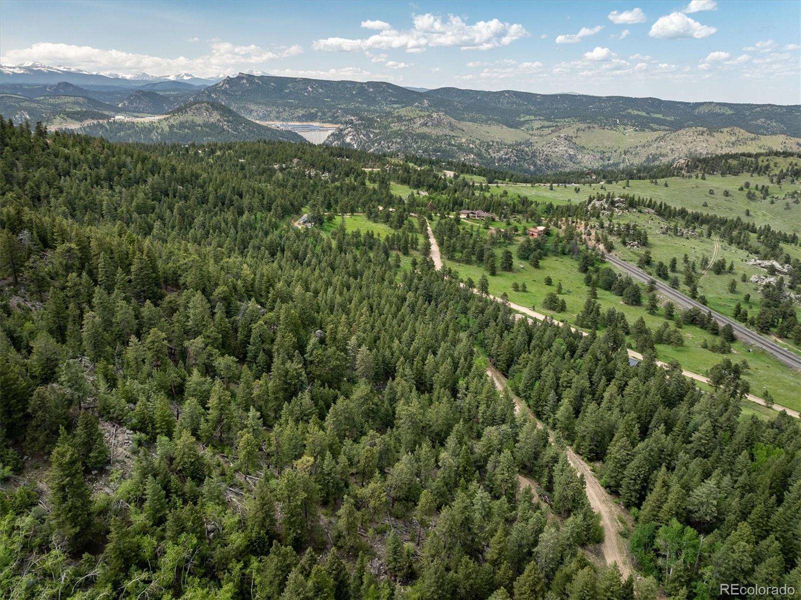 1546 Chute Road Golden, CO 80403 - Photo 31 of 36 a view of a lush green forest with mountains in the background