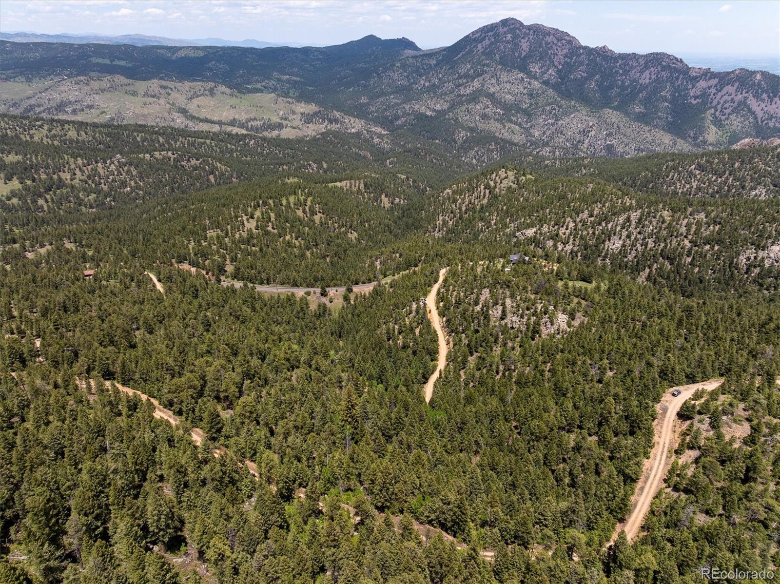 1546 Chute Road Golden, CO 80403 - Photo 33 of 36 a view of a lot of a lush green hillside and houses