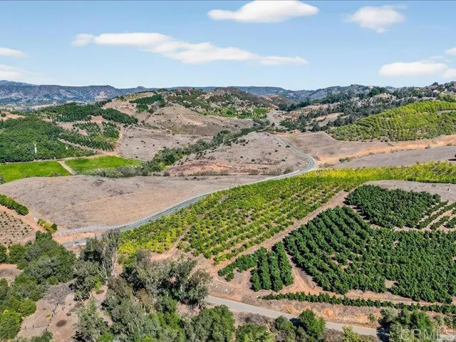 a view of a street with a lake