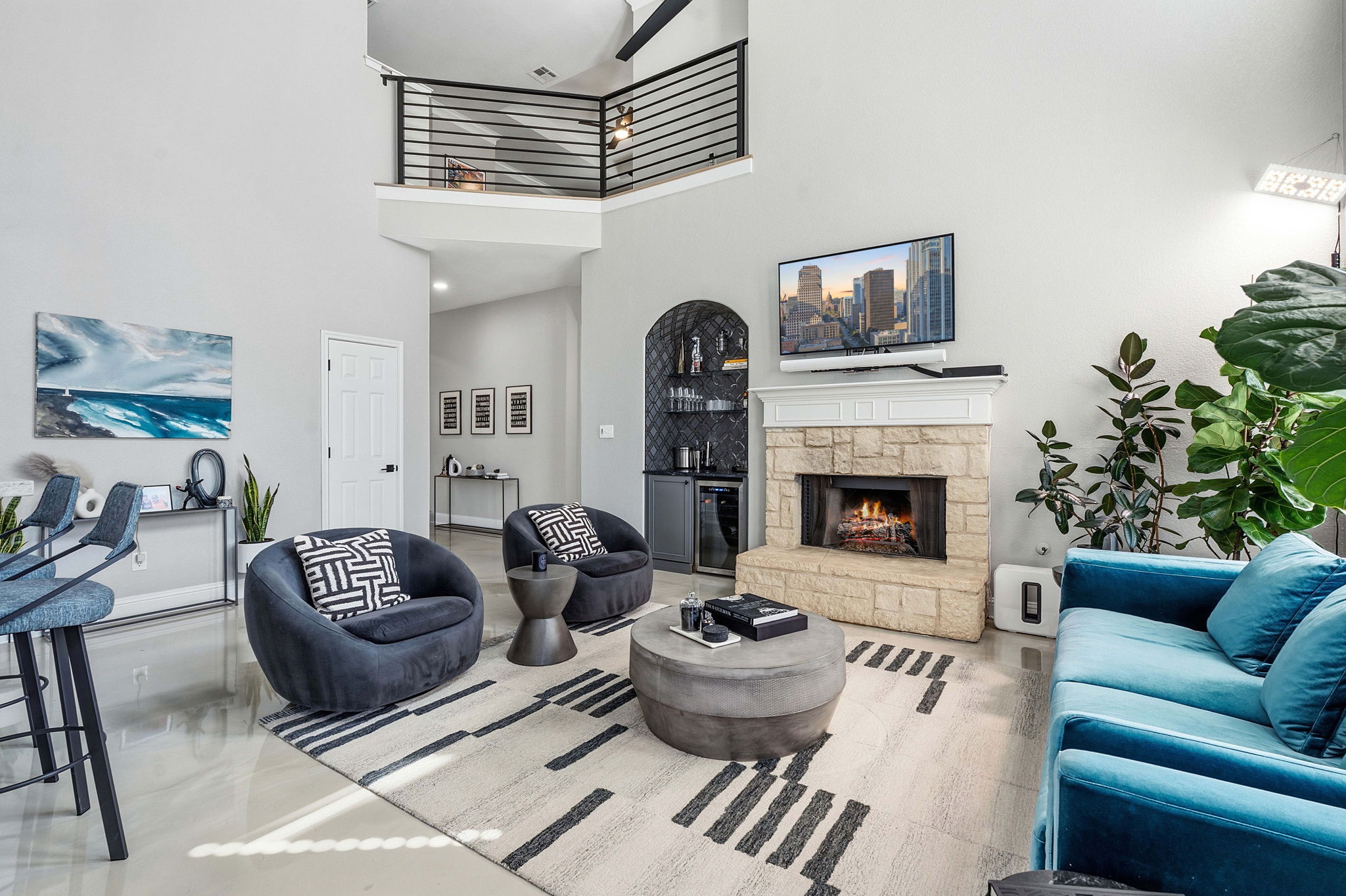 5000 Mission Oaks Boulevard, Unit 30 Austin, TX 78735 - Photo 4 of 31 Living area featuring a fireplace, wet bar, and a high ceiling for 5000 Mission Oaks Dr #30