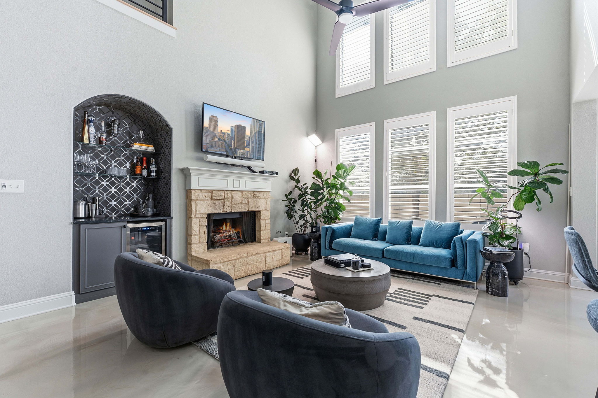 5000 Mission Oaks Boulevard, Unit 30 Austin, TX 78735 - Photo 9 of 31 Living area featuring a fireplace, wet bar, plantation shutters and a high ceiling for 5000 Mission Oaks Dr #30
