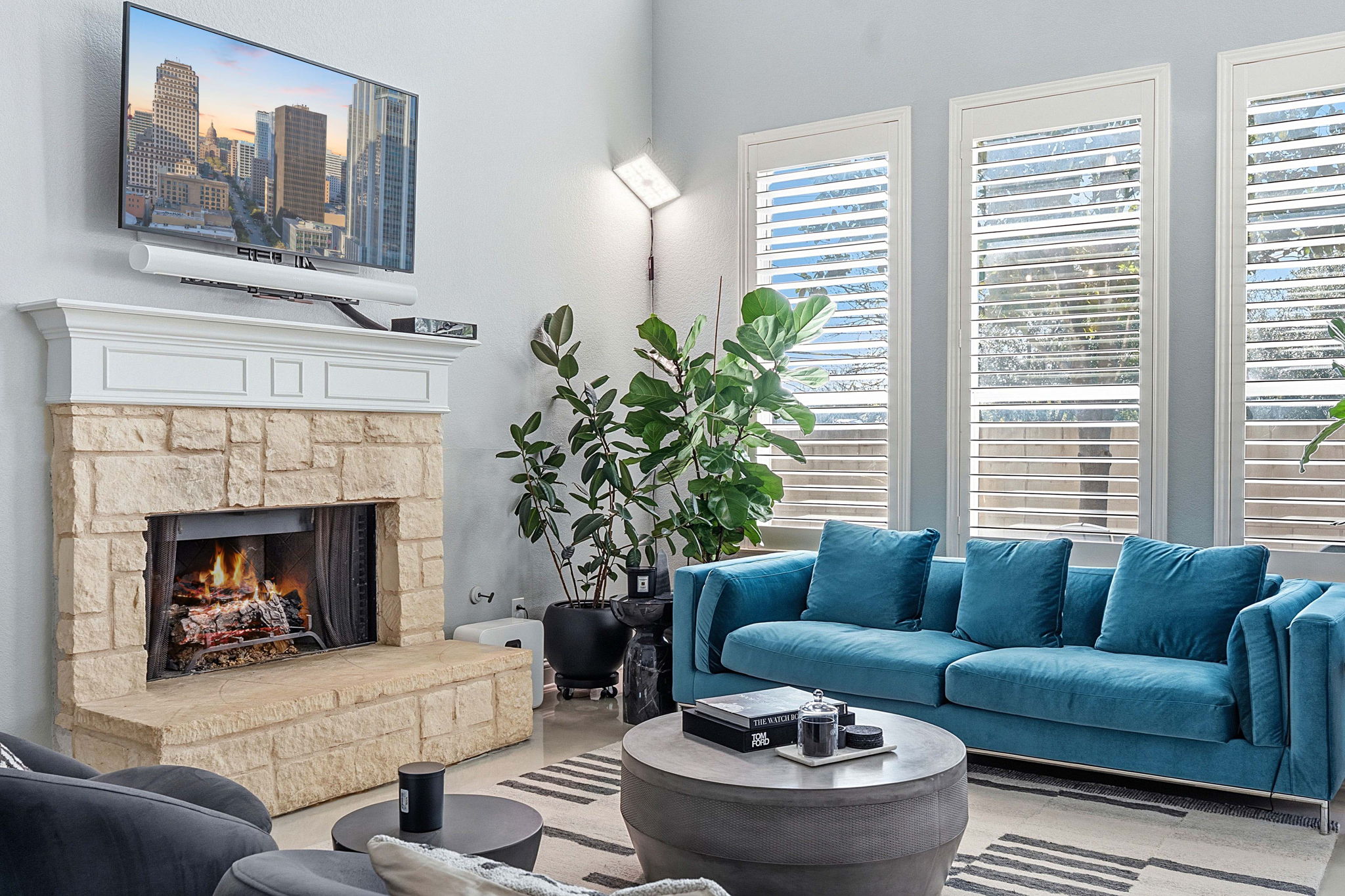 5000 Mission Oaks Boulevard, Unit 30 Austin, TX 78735 - Photo 10 of 31 Living area featuring a fireplace, wet bar, and a high ceiling for 5000 Mission Oaks Dr #30