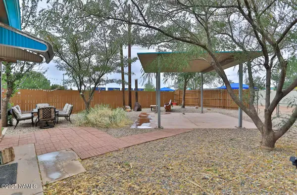 a backyard of a house with trampoline fire pit and iron fence