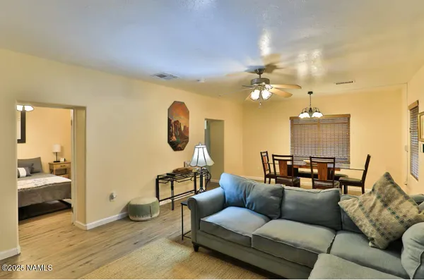 a living room with furniture and a chandelier