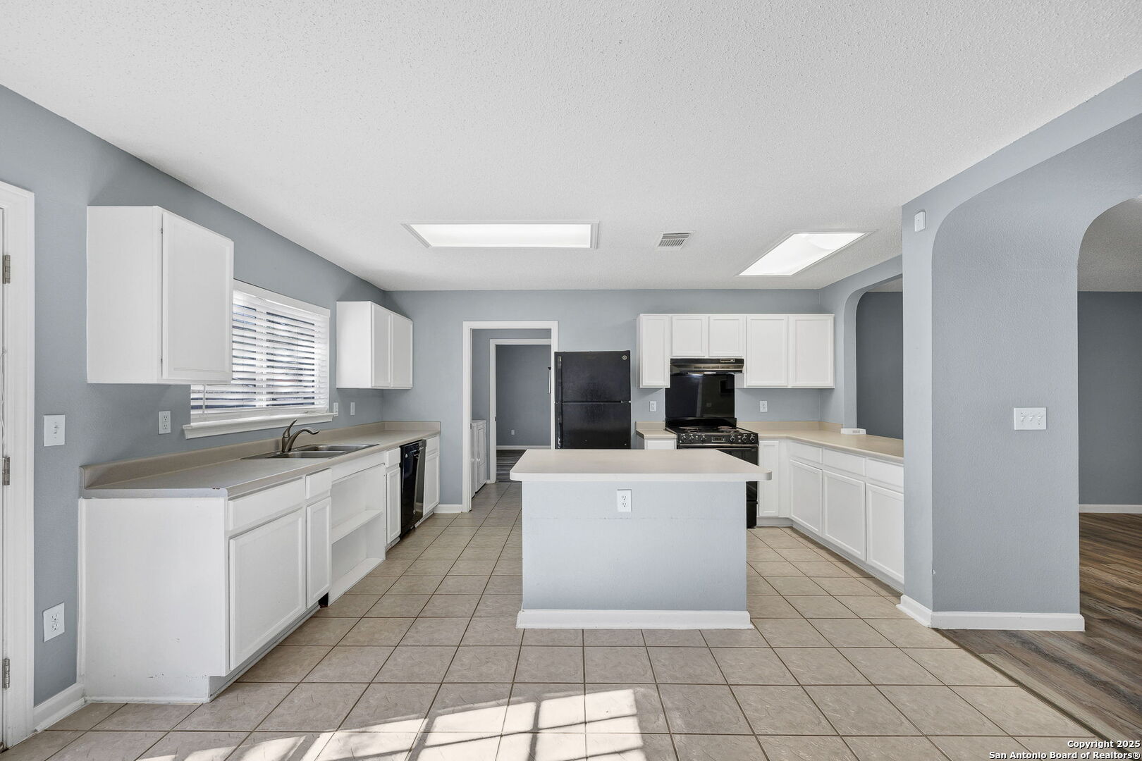 7362 Rustling Brook San Antonio, TX 78249 - Photo 11 of 36 a kitchen with a sink a counter top space and appliances