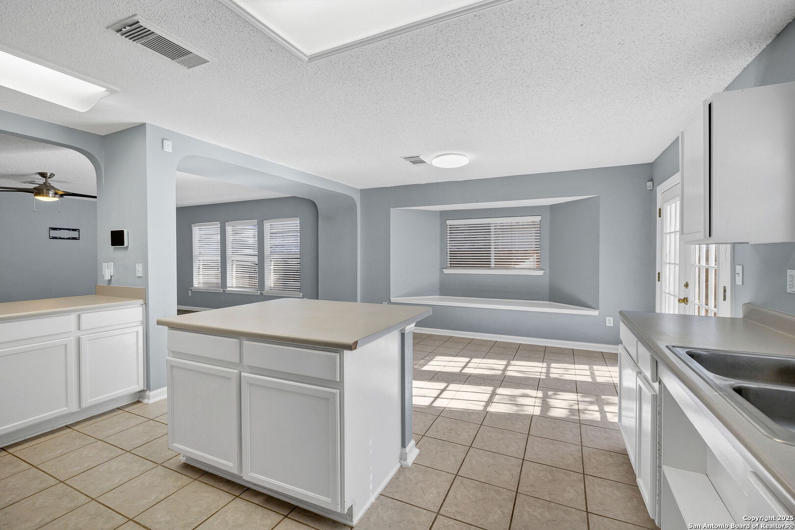 7362 Rustling Brook San Antonio, TX 78249 - Photo 13 of 36 a kitchen with white cabinets and appliances