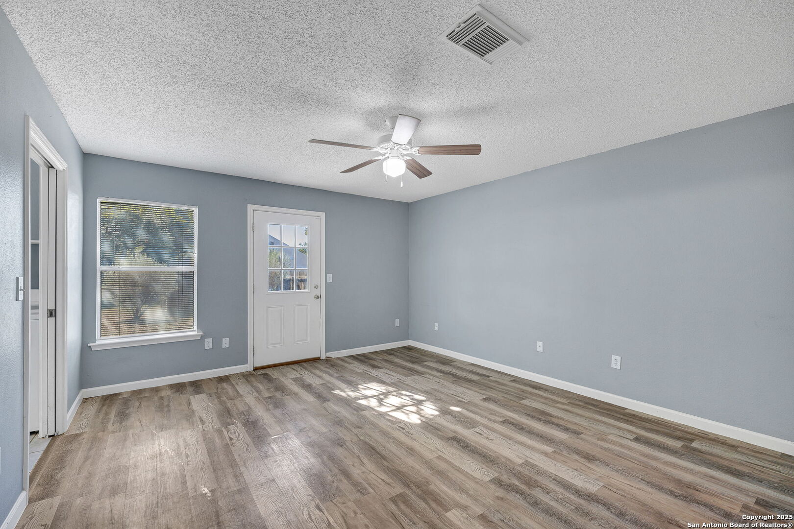 7362 Rustling Brook San Antonio, TX 78249 - Photo 16 of 36 wooden floor in an empty room with a window