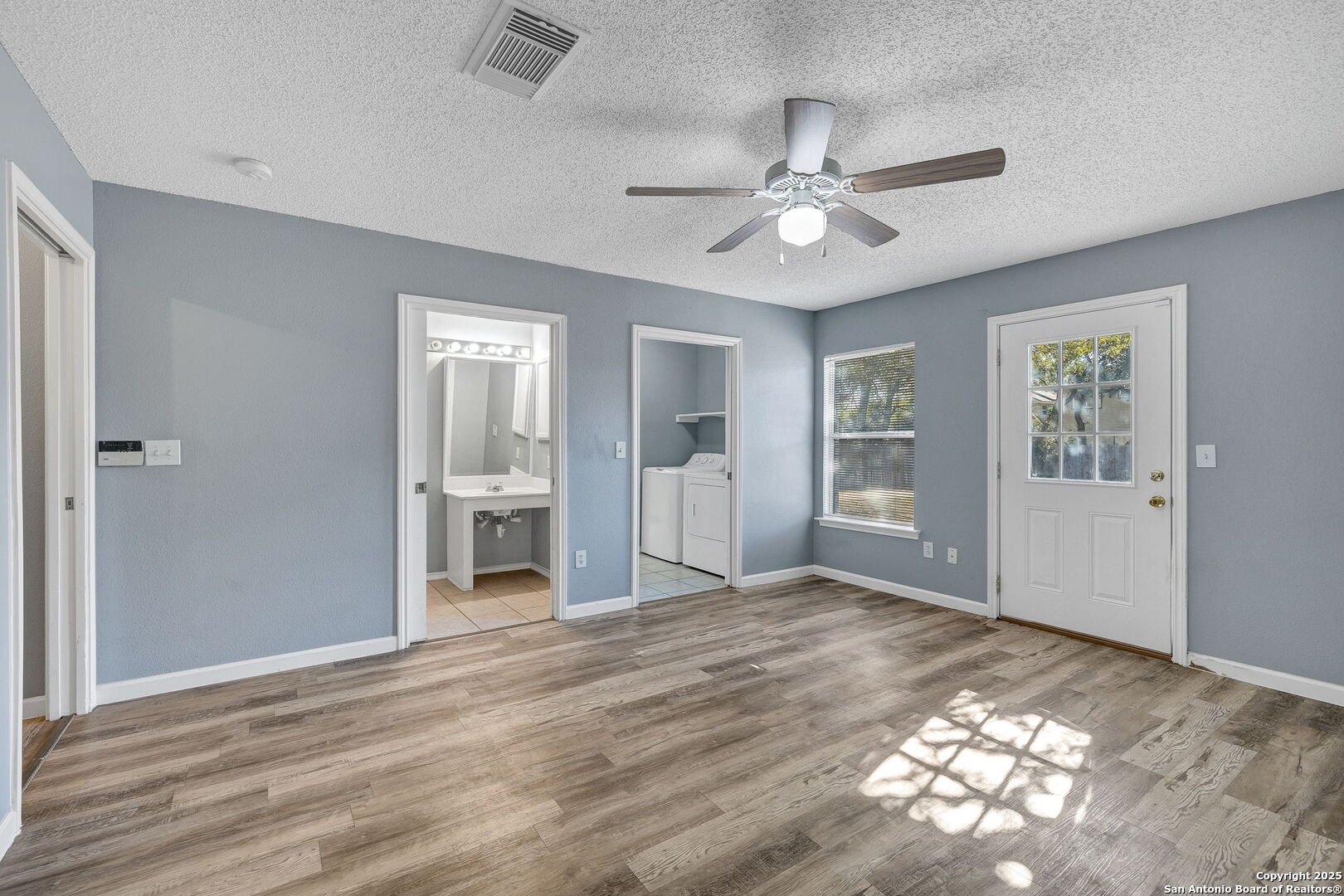 7362 Rustling Brook San Antonio, TX 78249 - Photo 17 of 36 a view of a livingroom with a chandelier fan and windows