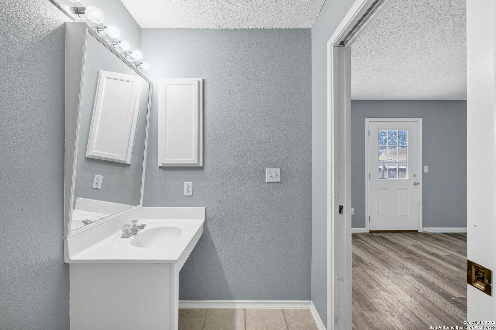 7362 Rustling Brook San Antonio, TX 78249 - Photo 22 of 36 a bathroom with a sink and a mirror
