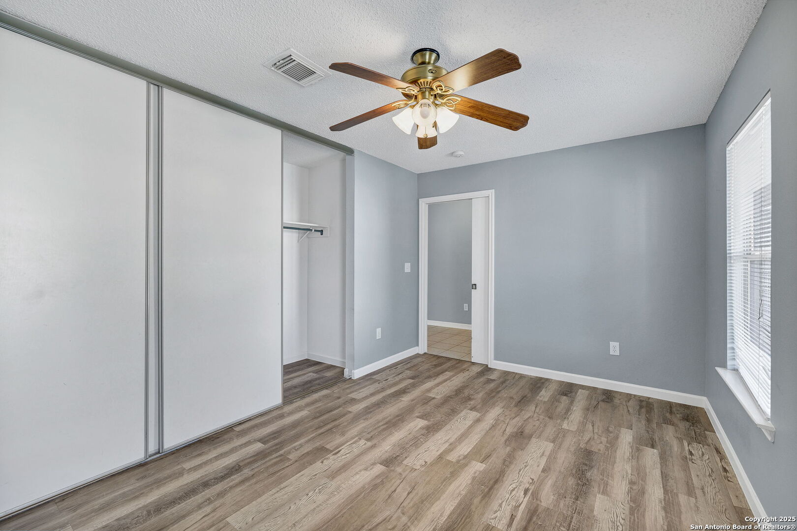 7362 Rustling Brook San Antonio, TX 78249 - Photo 31 of 36 wooden floor in an empty room with a window