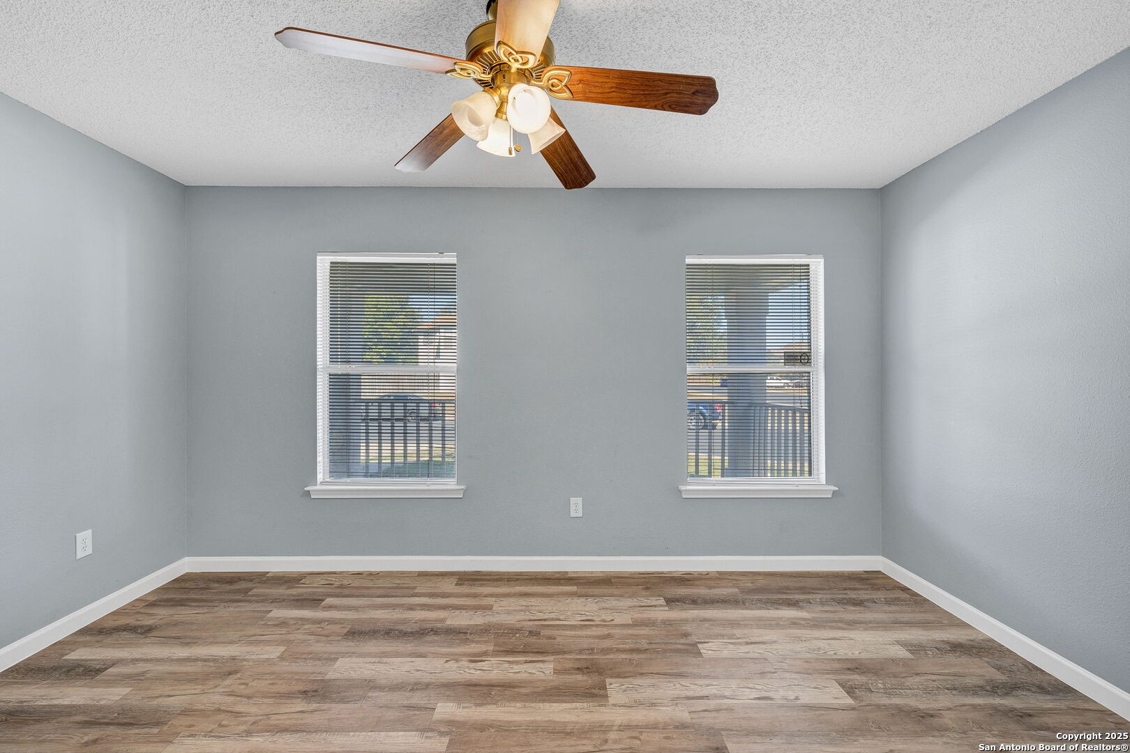 7362 Rustling Brook San Antonio, TX 78249 - Photo 32 of 36 a view of an empty room with window and wooden floor