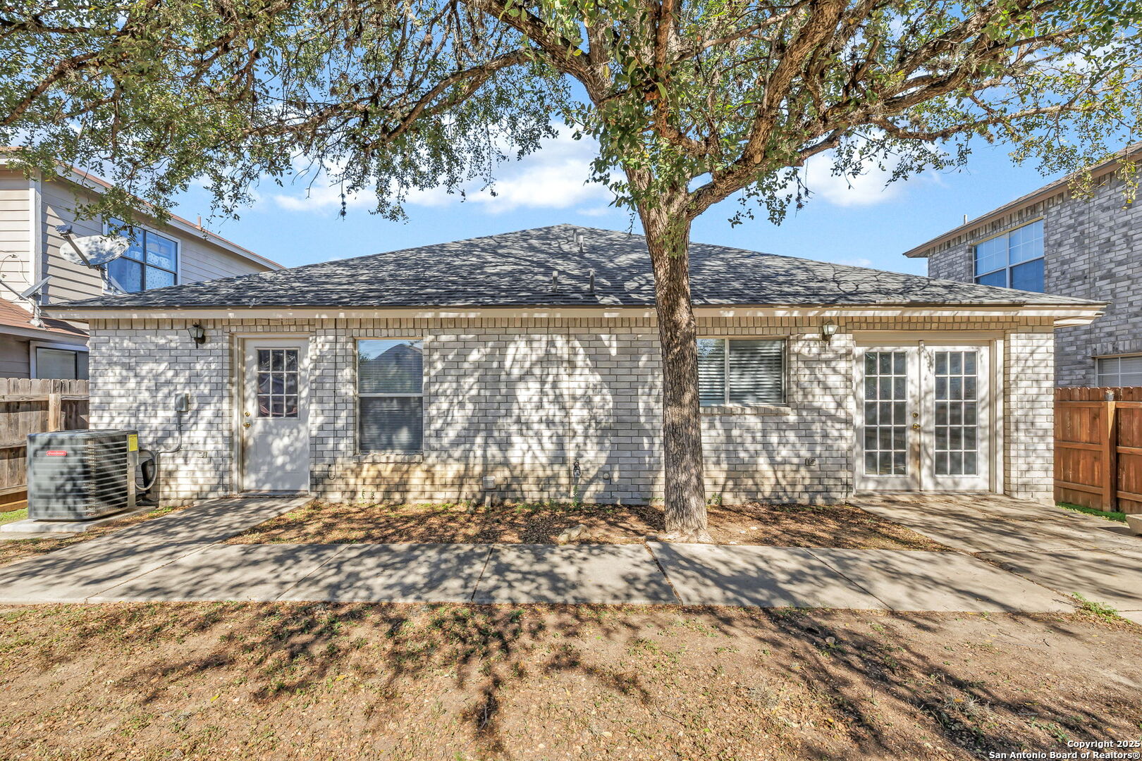 7362 Rustling Brook San Antonio, TX 78249 - Photo 34 of 36 a view of a house with a large tree and wooden fence