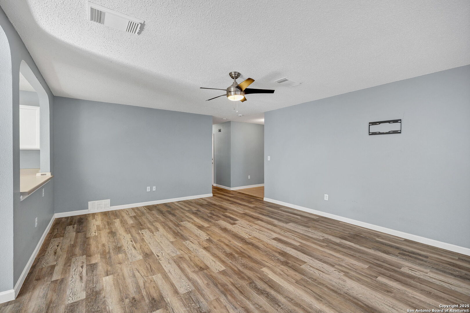 7362 Rustling Brook San Antonio, TX 78249 - Photo 8 of 36 wooden floor in an empty room with a window