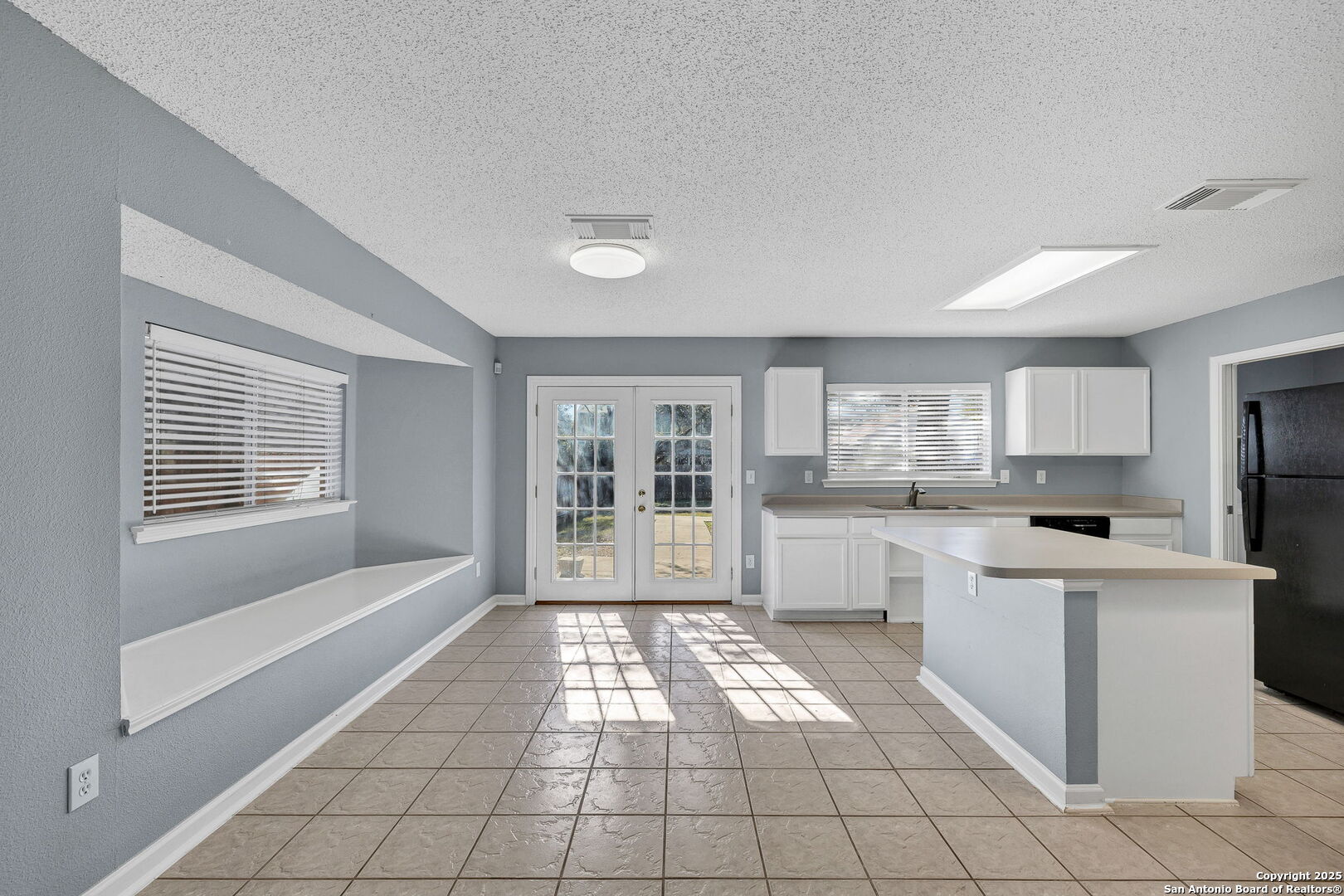 7362 Rustling Brook San Antonio, TX 78249 - Photo 10 of 36 a kitchen with white cabinets and white appliances