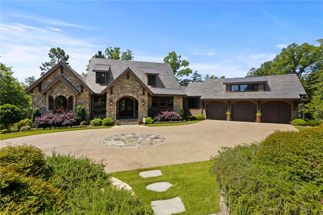 236 Palmer Way Sunset, SC 29685 - Photo 1 of 46 A grand stone facade welcomes you to this residence, complete with a circular driveway and lush landscaping.