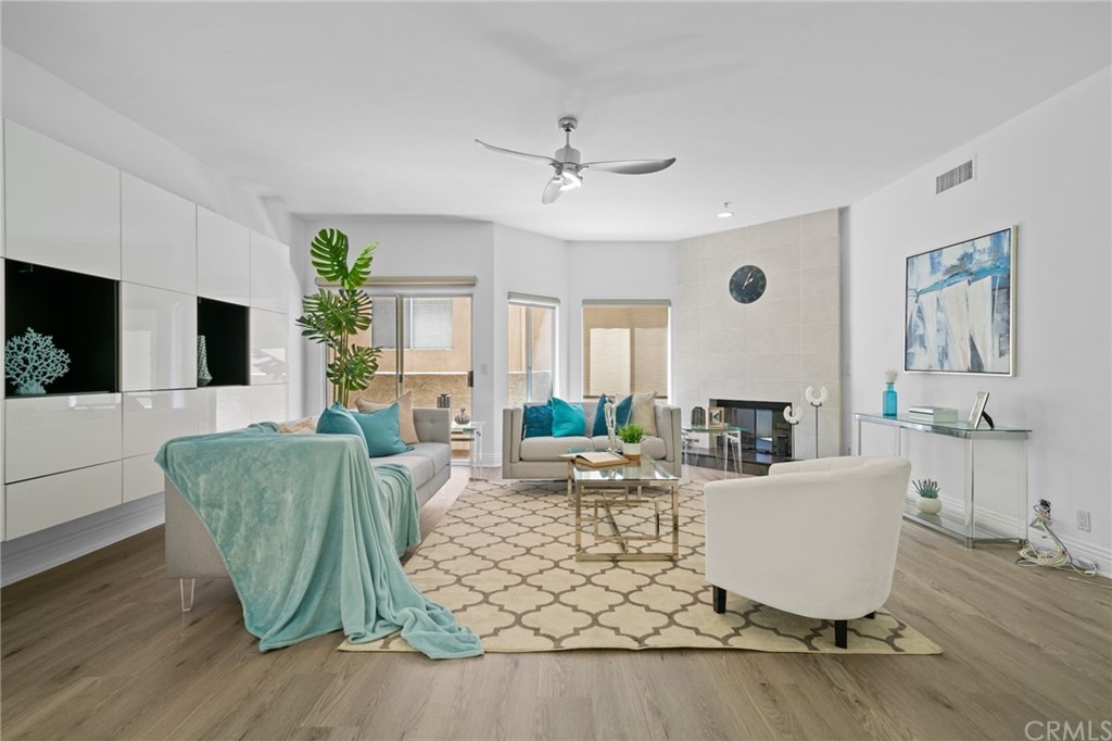 10604 Valley Spring Lane, Unit 201 Toluca Lake, CA 91602 - Photo 1 of 1 a living room with furniture a large window and a rug
