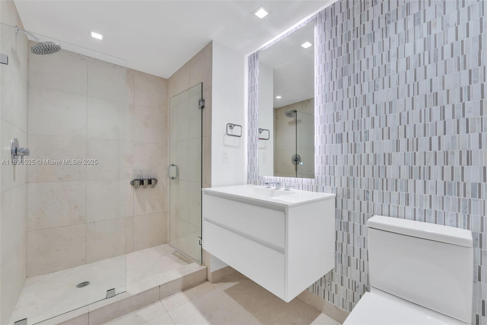 465 Brickell Avenue, Unit 4201 Miami, FL 33131 - Photo 11 of 16 a bathroom with a sink a toilet and shower