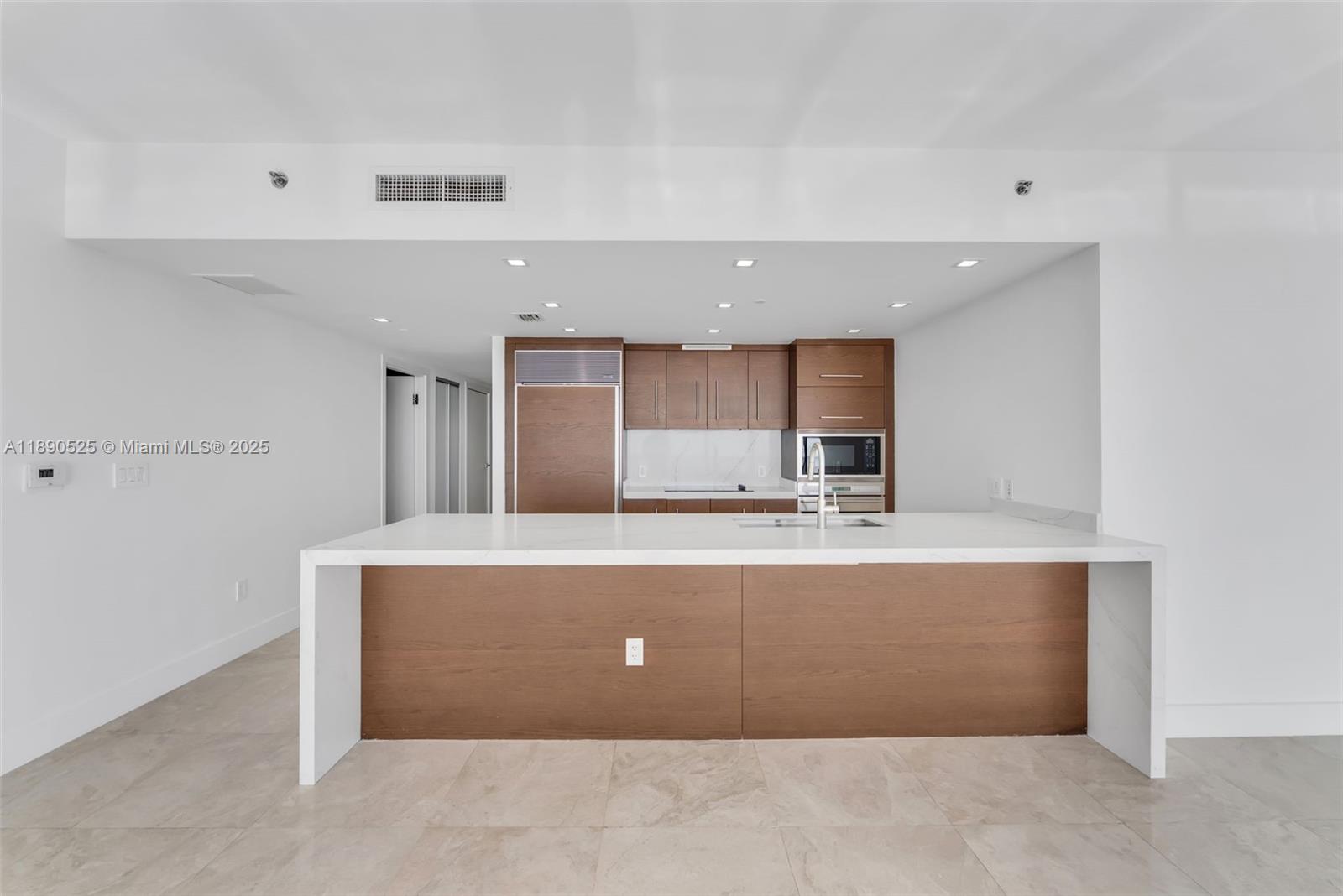 465 Brickell Avenue, Unit 4201 Miami, FL 33131 - Photo 3 of 16 a view with kitchen island a sink a stove and a refrigerator