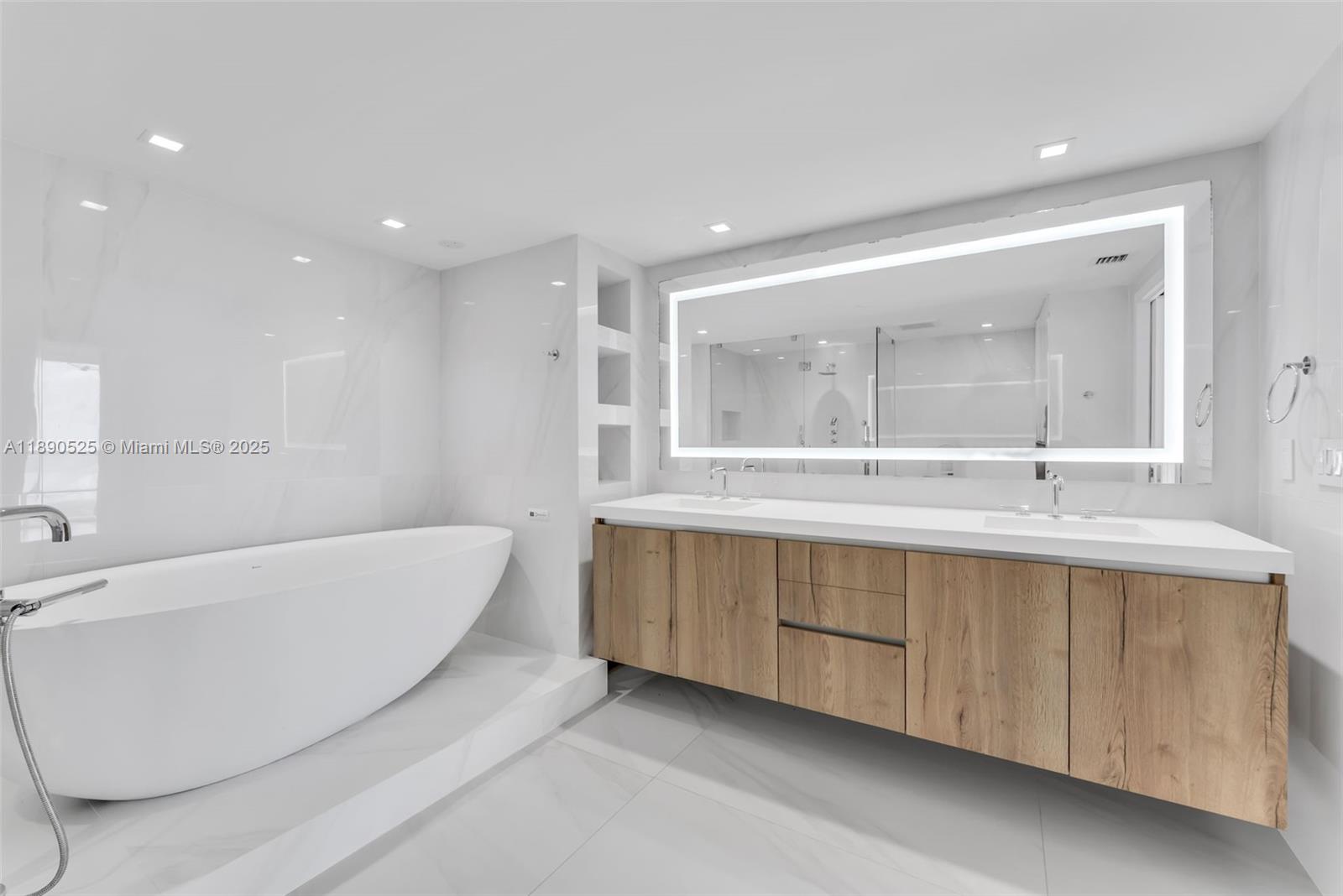 465 Brickell Avenue, Unit 4201 Miami, FL 33131 - Photo 7 of 16 a bathroom with a double vanity sink mirror and bathtub